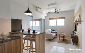 a kitchen and living room with a counter and a living room at Alanis 15mins KLIA KLIA2 in Kampong Bekoh