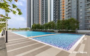 a swimming pool in a city with tall buildings at Alanis 15mins KLIA KLIA2 in Kampong Bekoh