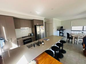 a kitchen with a sink and a counter top at Spacious 5-BR Home with Fenced Yard in West Hoxton