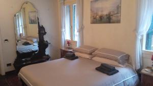 a bedroom with a bed and a large mirror at Ca' Toletta in Venice
