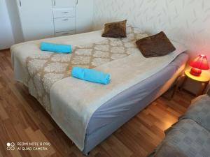 two blue pillows on a bed in a room at New home in the citycenter. in Rovaniemi