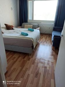 a bedroom with a bed with two towels on it at New home in the citycenter. in Rovaniemi