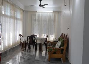 a dining room with a table and chairs at Apurna Guest House Dawki in Dawki