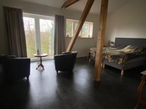 a bedroom with a bed and a table and chairs at Spacious holiday home in the Teutoburg Forest in Schieder-Schwalenberg