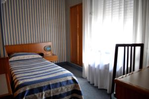 Postel nebo postele na pokoji v ubytování Hotel Garda
