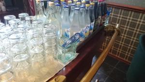 a table with many empty bottles and glasses on it at Stadshotellet Sölvesborg in Sölvesborg
