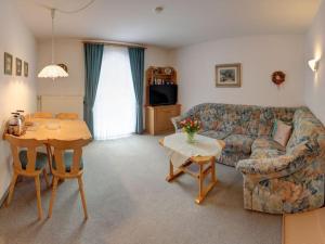 a living room with a couch and a table at Lovely holiday home near ski-lift in Inzell