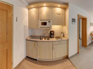 a kitchen with a sink and a microwave at Lovely holiday home near ski-lift in Inzell