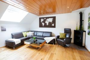 a living room with a couch and a table at Appartement Riedingtal in Zederhaus