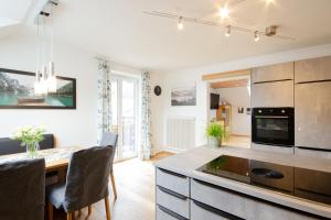 a kitchen with a table and a dining room at Appartement Riedingtal in Zederhaus