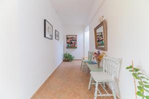 a hallway with chairs and a table and a mirror at Kassiani Studios in Plakias