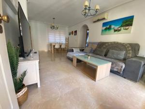 a living room with a couch and a table at Can Guerrero pet friendly a 500 metros de la playa! in Calas de Mallorca
