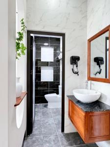 a bathroom with a sink and a toilet at Hula Hotel in Can Tho