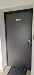 a large metal door with a sign on it at HYDE PARK APARTMENTS in Čakovec
