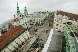 an overhead view of a city street with buildings at Hotel Corvinus Vienna in Vienna