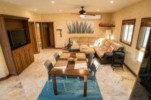 a living room with a couch and a table and chairs at Cabo's Hidden Gem! Steps to the Marina or Beach in Cabo San Lucas
