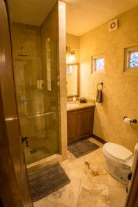 a bathroom with a shower and a toilet and a sink at Cabo's Hidden Gem! Steps to the Marina or Beach in Cabo San Lucas