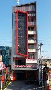 a tall building with a red rectangle on it at Hotel Brothers Inn Babarsari in Seturan