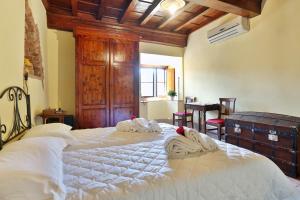 a bedroom with two beds with towels on them at Villa D'Arte Agri Resort in Pontassieve