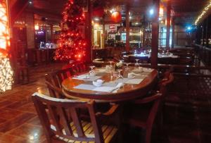 a dining room with a christmas tree in a restaurant at RedDoorz at Amphibi-ko Resort Palawan in Coron