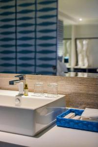 a bathroom with a sink with glasses on it at Astoria Current in Boracay