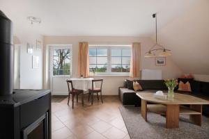 a living room with a couch and a table at Ferienwohnung Coni in Langballig