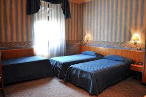 Postel nebo postele na pokoji v ubytování Hotel Garda