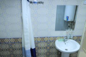 a bathroom with a sink and a mirror at Hotel ALISHER in Bukhara
