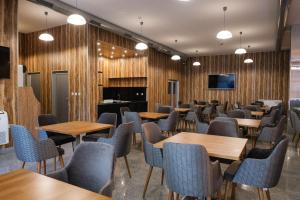 comedor con paredes de madera, mesas y sillas en HOTEL BAYKO en Plovdiv