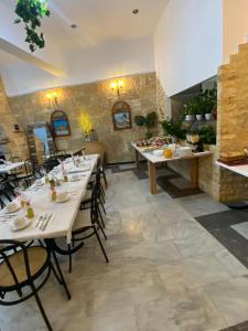 a restaurant with tables and chairs in a room at Costas Inn in Spílion