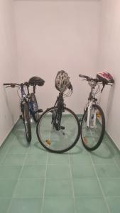 three bikes parked next to each other on a floor at B8 apartment in Bohinj