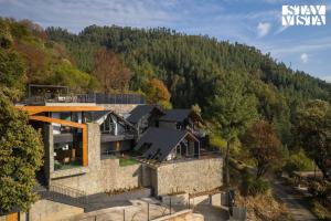 an aerial view of a house in the mountains at StayVista at Shai Sher Estate with Bonfire, BBQ and Lawn in Shimla