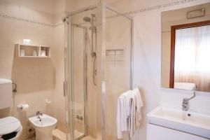 a bathroom with a shower and a toilet and a sink at Hotel Pardini in Viareggio +99 photos