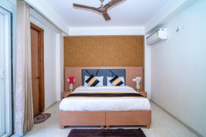 - une chambre avec un lit et un ventilateur de plafond dans l'établissement Aster Studio Sec-39 Gurgaon I Fully furnished 2BHK, à Gurgaon