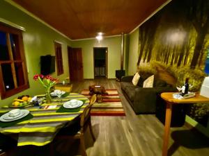 a living room with a table and a couch at Strip Center Suites by Casona Lo Aguirre in El Monte