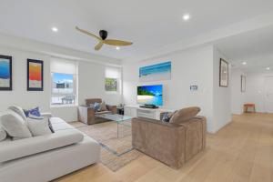 a living room with a couch and a table at The Beach Apartment in Huskisson