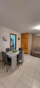 a dining room with a table and chairs at Appartamento Limone in Cala Gonone