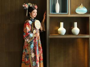 a doll of a woman in a kimono holding a plate at China World Hotel, Beijing in Beijing