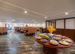 a cafeteria with a table with plates of food on it at Sapa Luxury hotel & Spa in Sa Pa