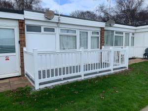 una cerca blanca frente a una casa en 54 Belle Aire Hemsby en Hemsby