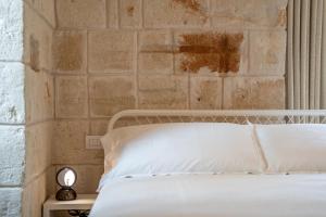 Postel nebo postele na pokoji v ubytování Innesto Rooms - Monopoli