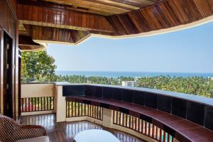 a balcony with a view of the ocean at ATREYA AYURVEDA BEACH RETREAT in Kovalam