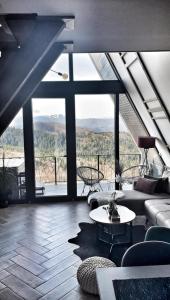 a living room with a couch and a table at Jahorina Luxury Chalets in Jahorina