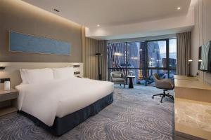 a hotel room with a bed and a large window at Holiday Inn - Nanjing South Station by IHG in Nanjing +83 photos