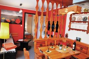 a dining room with a table and utensils on the wall at Ferieneinrichtungen-Haus-am-Stein in Königstein an der Elbe