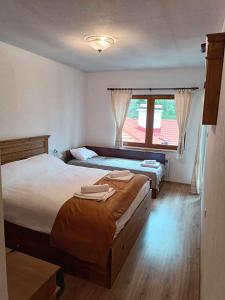 Un dormitorio con dos camas y una ventana. en Villa Victoria, en Stoykite