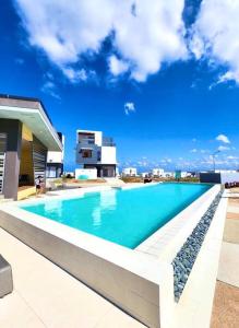 a swimming pool on top of a building at Cityscape Villas-Batulao Artscapes in Balibaguhan