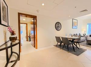 a dining room and living room with a table and chairs at Trinity Holiday Homes - Sheikh Zayed Road Near to Financial Center Metro Station in Dubai