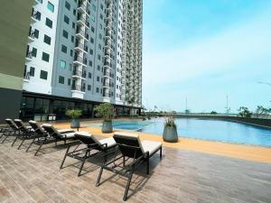 a row of chairs sitting next to a swimming pool at OSAKA RIVERVIEW in Tangerang