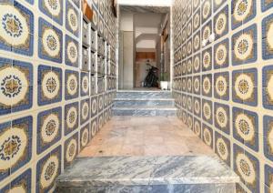 a hallway with blue and white tile walls at Amazing Getaways in Amora